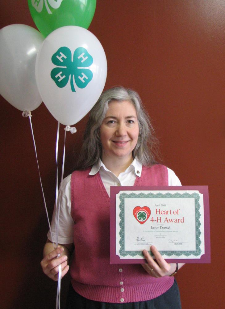 Jane Dowd holding balloons and a certificate
