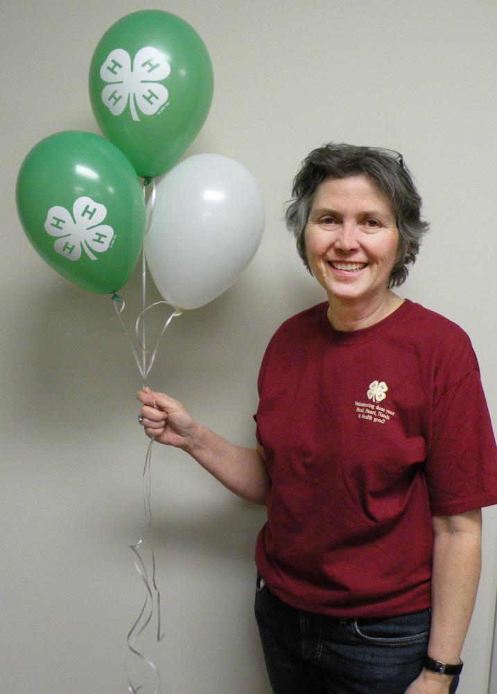 Kath Conroy holding 4-H balloons.