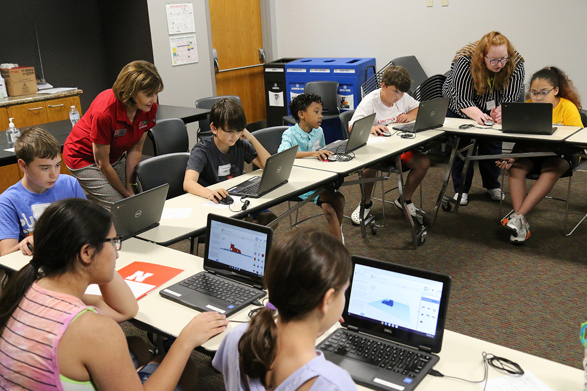 several youth looking at computers