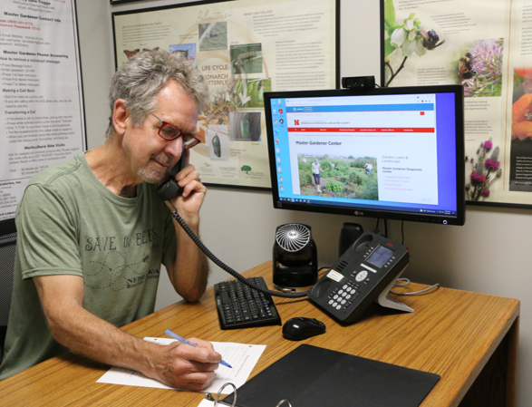 Image of Extension Master Gardener phone answering volunteer. 