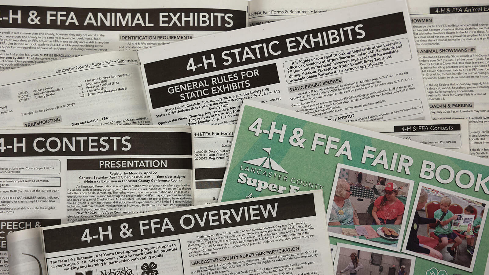 Stack of 4-H & FFA Fair Books open to different pages