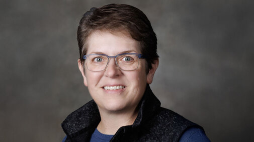 Portrait of Becky Schuerman, with a textured photography screen in background