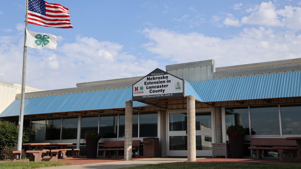 Front of a building on a cloudy day with flags flying