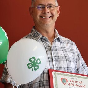 Shane Cuttlers hold certificate and balloons 