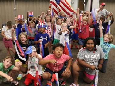 a group of youth holding patriotic items