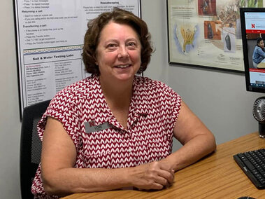 A smiling woman sitting at a desk