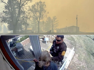 Smoky sky over trees and rural buildings; below, a person interacts with a law enforcement officer on a porch.