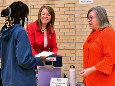 Two adult women talking to a teen