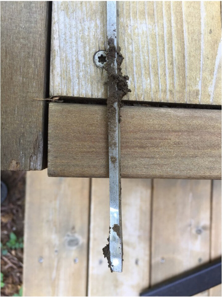 Image of a screwdriver with soil caked on, indicating it was stuck into the ground