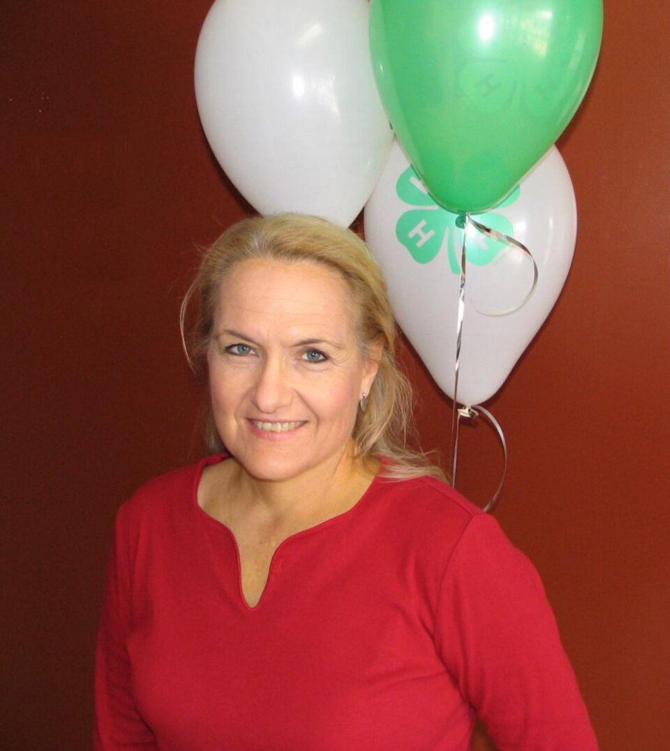 Becky Grimes standing in front of balloons 