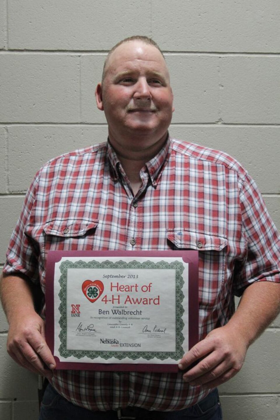 Ben Walbrecht holding a certificate. 