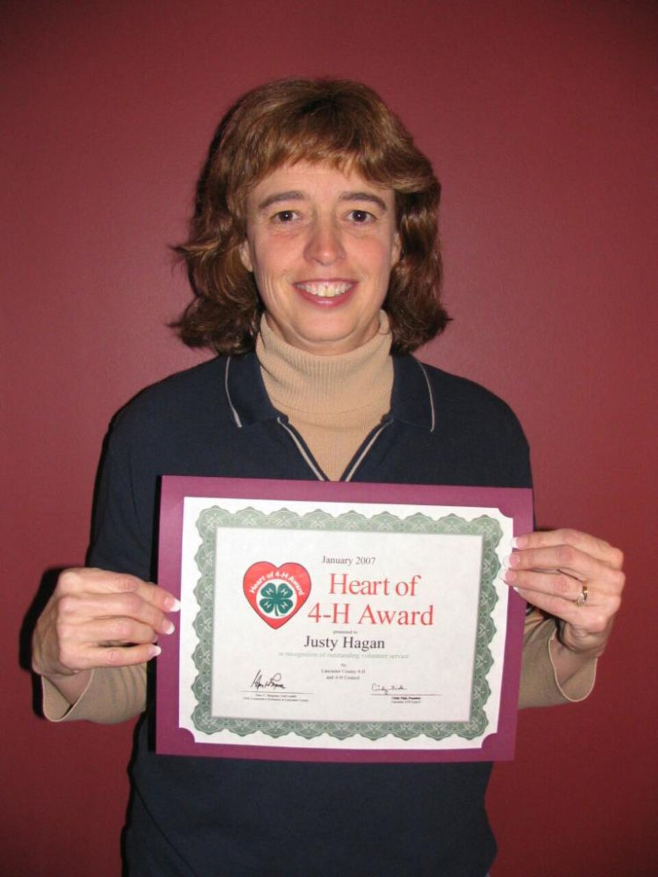 Justy Hagan holding a certificate 