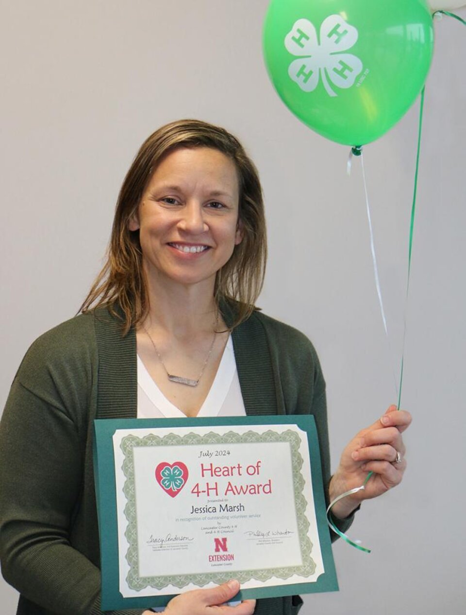 Jessica Marsh holding balloons and certificate. 