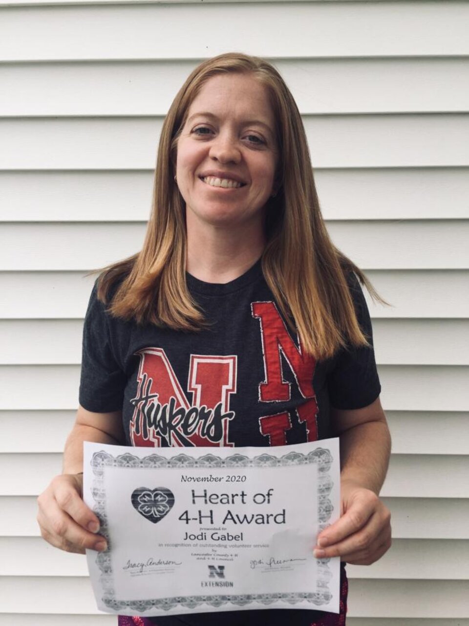 Jodi Gabel holding a certificate. 