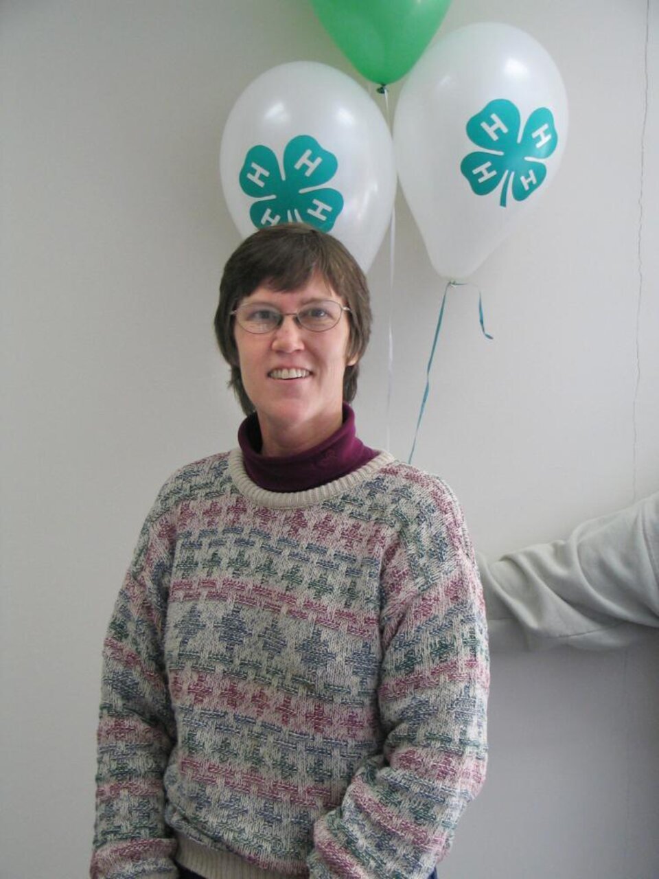 Kendra Ronnau standing in front of balloons 