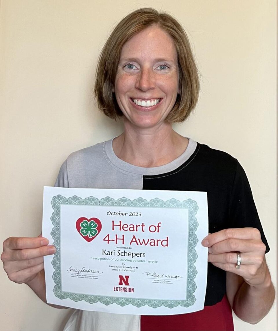 Kari Schepers holding Heart of 4-H Certificate 