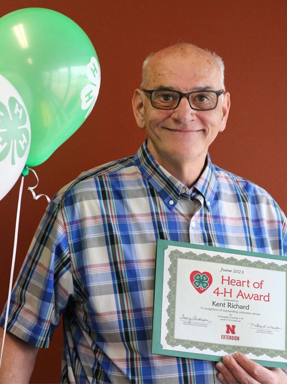 Kent Richard holding certificate and balloons 