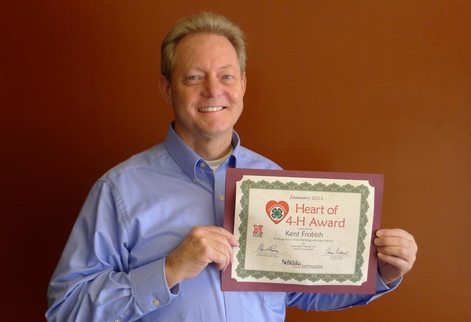 Kent Frobish holding a certificate. 