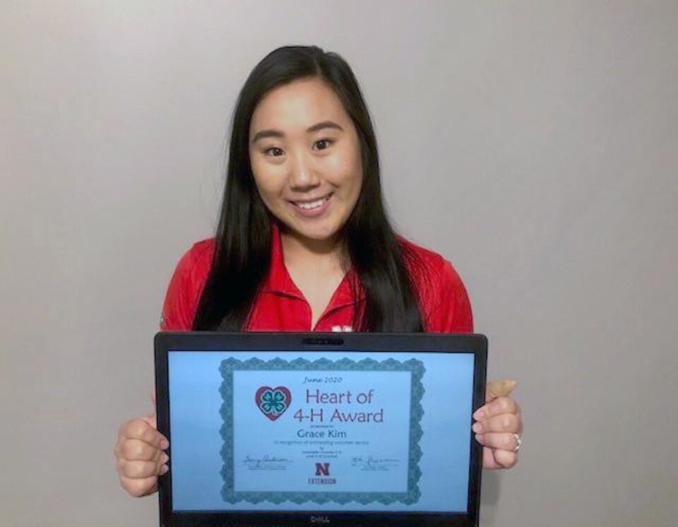 Grace Kim holding a certificate. 