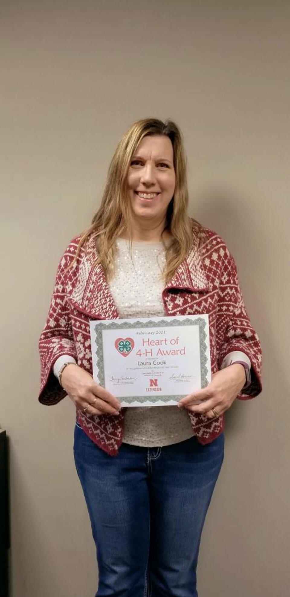 Laura Cook holding a certificate. 