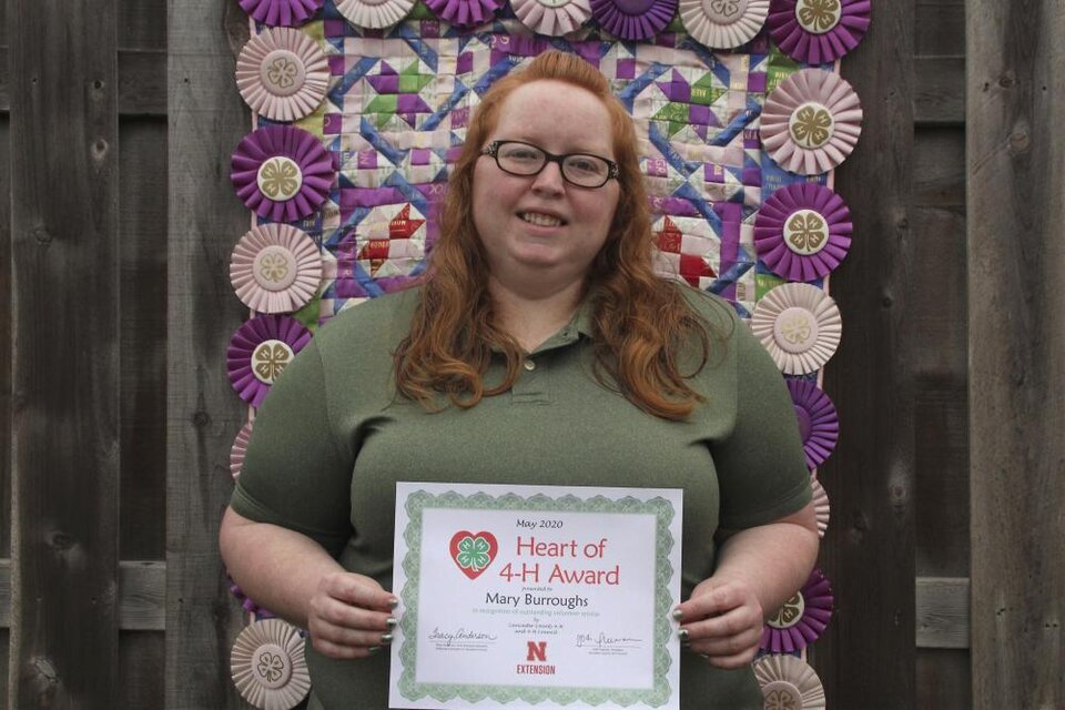 Mary Burroughs holding a certificate. 