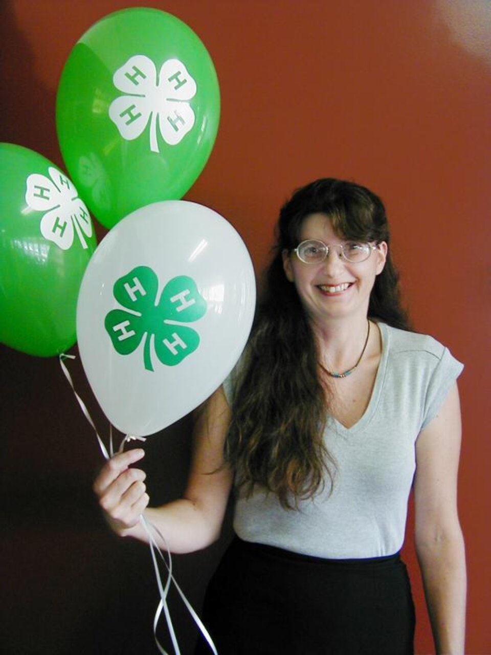 Paula Peterson holding balloons. 