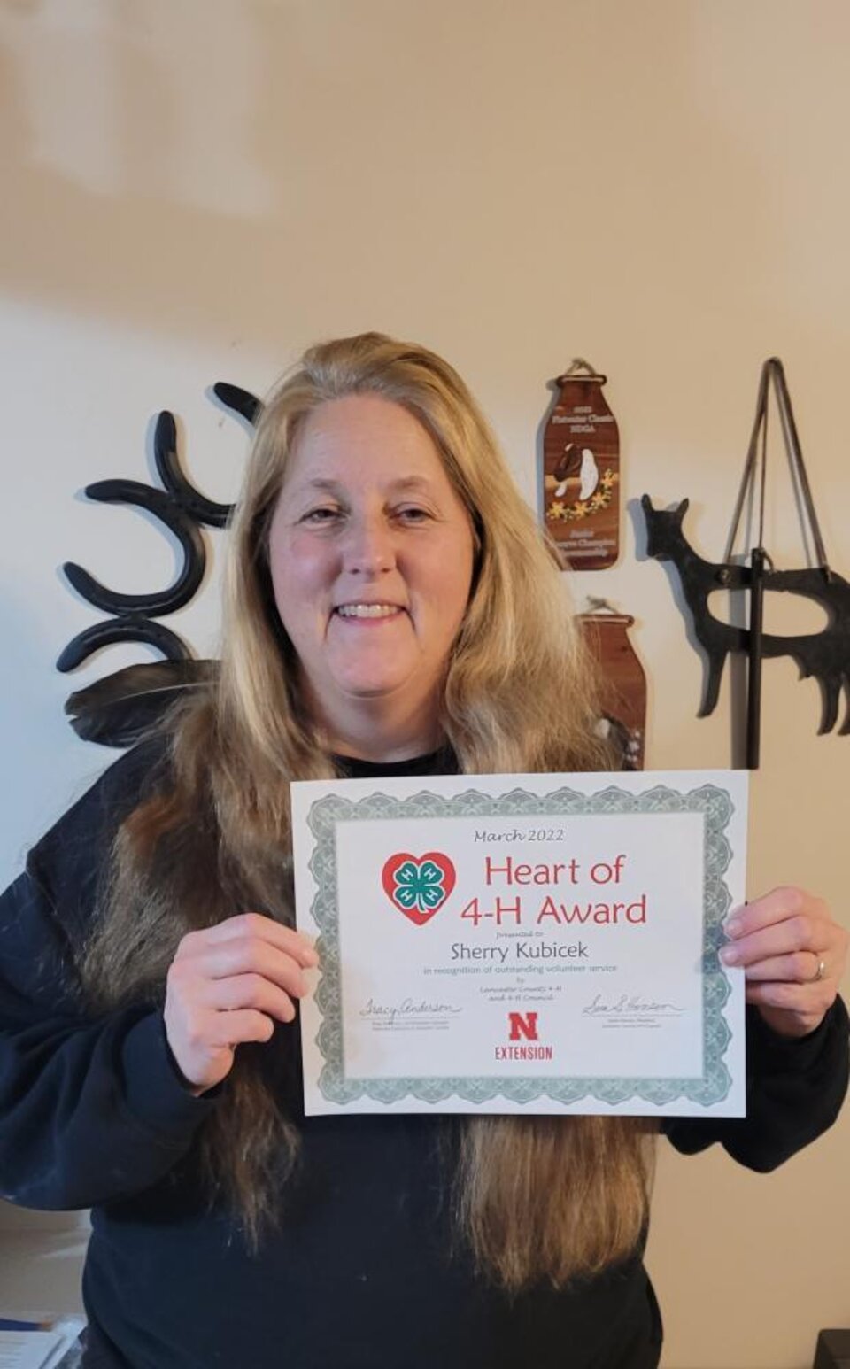 Sherry Kubicek holding a certificate. 