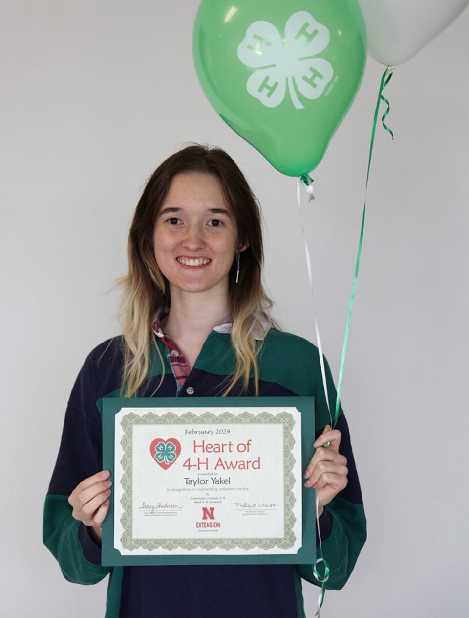 Woman holding certificate and balloon 