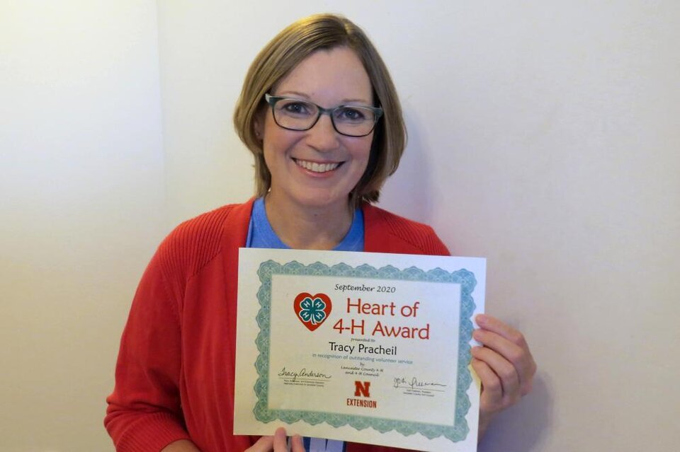 Tracy Pracheil holding a certificate. Tracy Pracheil holding a certificate.