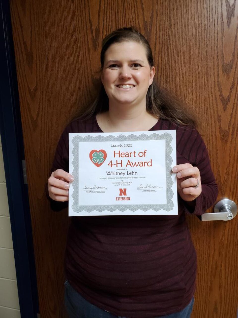 Whitney Lehn holding a certificate. 