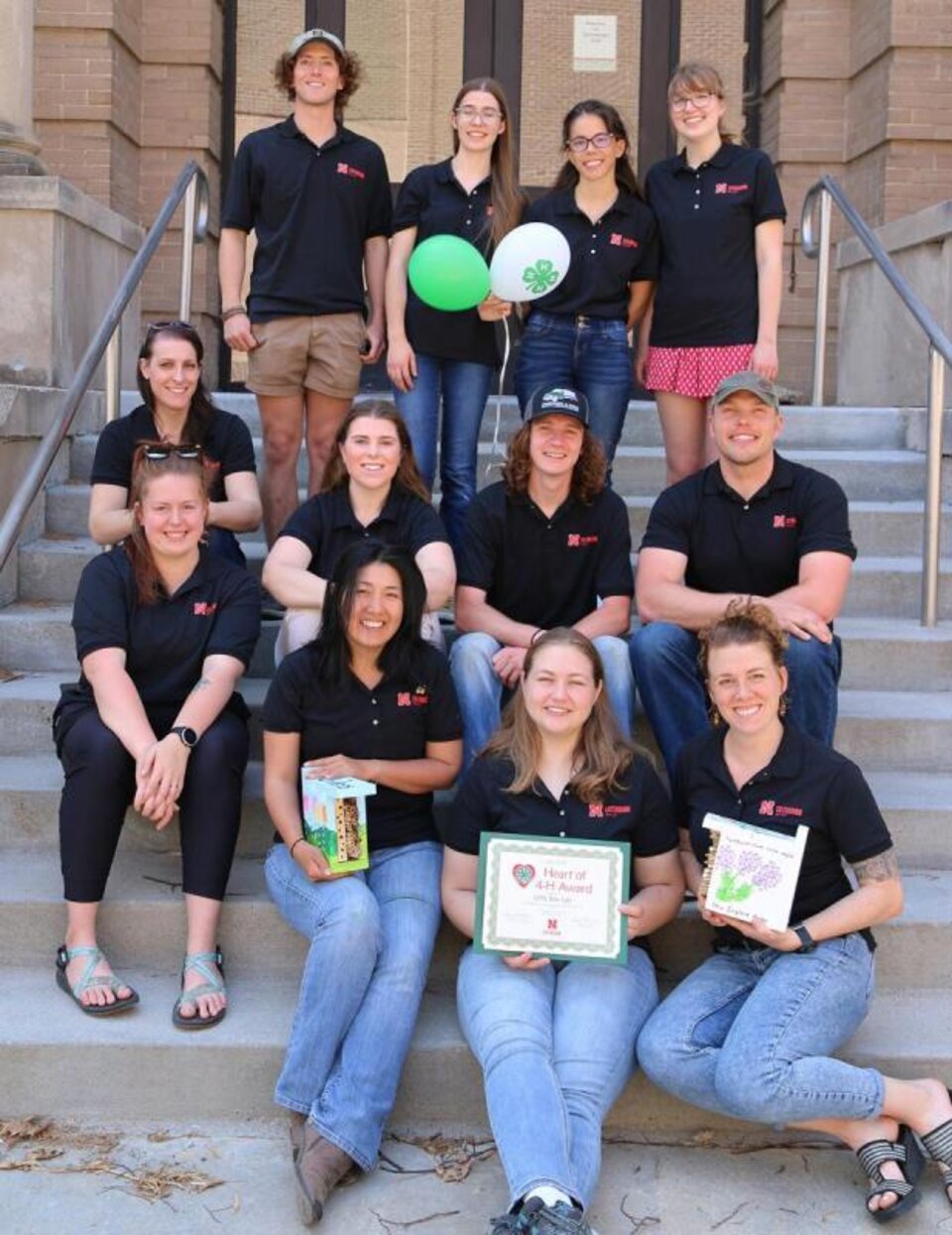 UNL Bee Lab gathered on their building stairs to accept the award. 